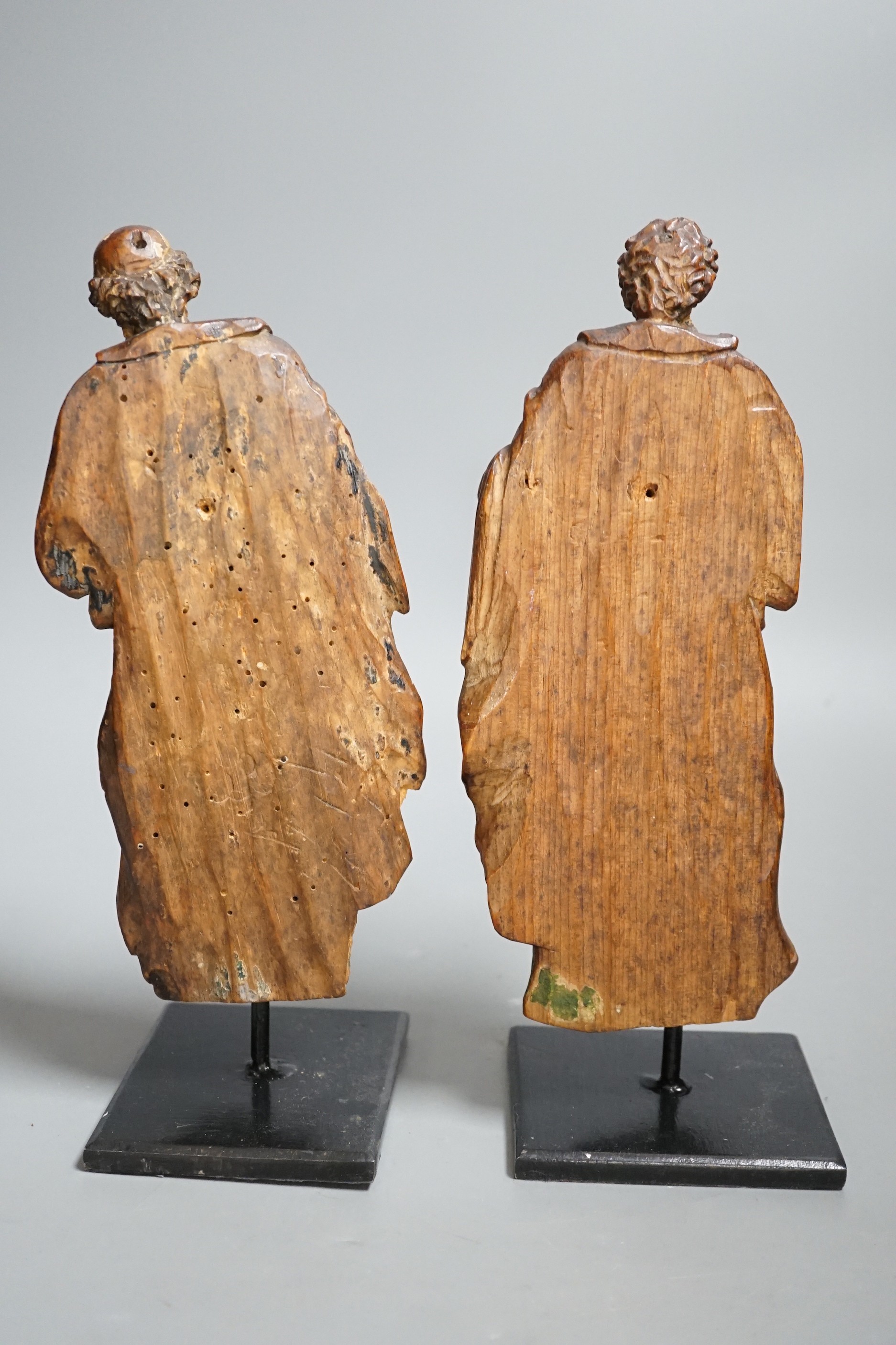 A pair of 17th century carved and painted pine figures. Tallest 26cm